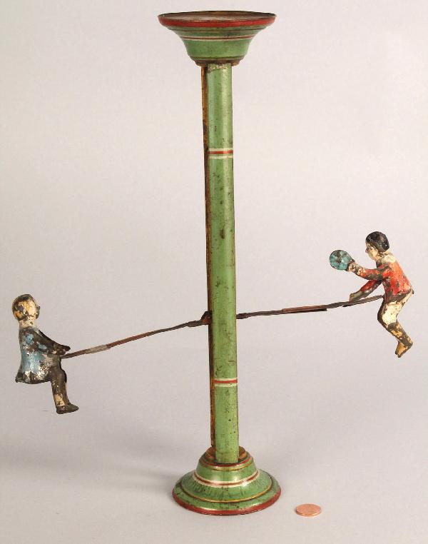 Gibbs Never Stop See-Saw: Gibbs Never Stop See-Saw, hand painted tin with boy and girl figures on each end. Manufactured in Canton, OH with stamped manufacture date of Sept. 15, 1903. Good condition with overall losses/wear to