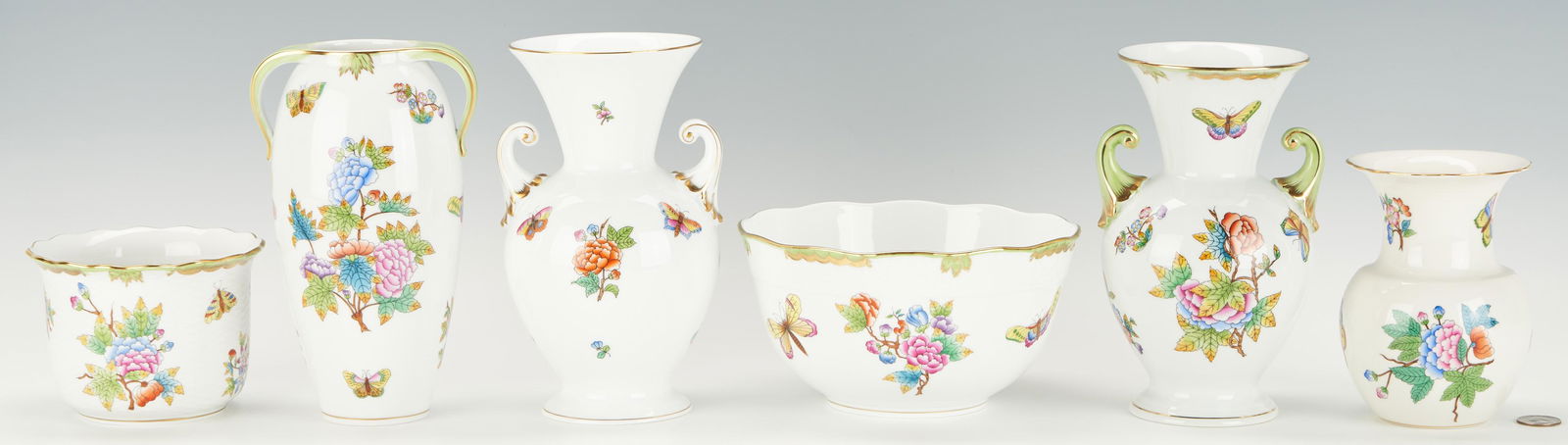 6 Herend Queen Victoria Vases & Cachepots: Six (6) Herend Queen Victoria pattern hand-painted porcelain table accessories and serving items, including one (1) urn shaped vase with a green border (7 3/4" H); one (1) cachepot with a scalloped ri