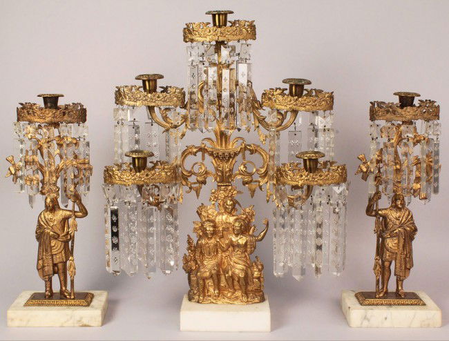 Cornelius & Co. Girandole Garniture, Daniel Boone: Three piece gilt bronze girandole garniture set with snowflake prisms, "Daniel Boone" pattern. Center girandole depicting figures from James Fenimore Cooper's "Leather Stocking Tales " and commonly as