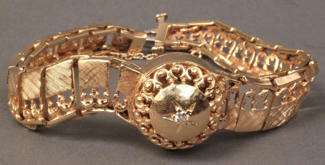 Ladies 14K Lucien Piccard wristwatch: Ladies 14K marked yellow gold Lucien Piccard wristwatch with hinged cover and brushed gold serpentine links. Watch does not appear functional. 7" L plus safety chain. 28.7 total weight. Provenance: Ko