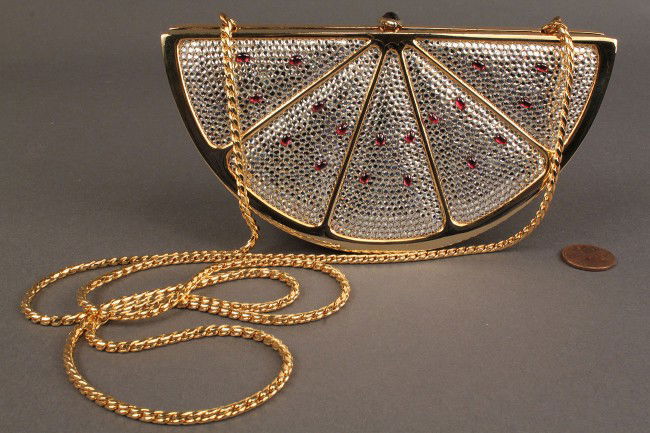 Judith Leiber Watermelon Minaudiere Purse: Judith Leiber small handbag or minaudiere, watermelon design, with hidden chain shoulder strap and small gold comb. Signed gold medal plaque inside purse. Condition: one red "seed" missing, latch tend