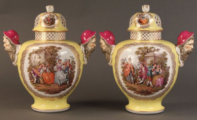 Pair of Sevres-style covered vases, yellow: Pair of Sevres style yellow ground covered vases with mask handles, one side decorated with figures in pastoral scene, the other side with large floral spray. Scenes are hand painted. Lids with pierce