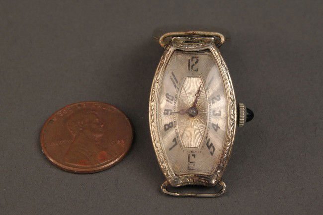 Ladies Chopard 18K white gold watchface: Ladies Chopard 18K white gold watch face, barrel form. Marked "J.W. Chopard Swiss seventeen 17 jewels four 4 adjusts" on the works, and case marked "18K". 1-1/4" L. Loose crystal and wear to watch fac