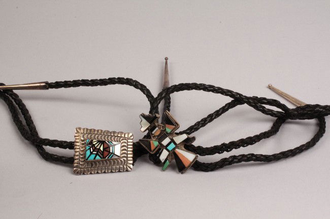 Lot of 2 Southwestern silver Bolo Ties: Lot of 2 Southwest Bolo Ties. 1ST ITEM: Native American Bolo tie with sterling Zuni Eagle Dancer, turquoise, mother of pearl and onyx stones. Condition: Missing section of onyx to one wing. Leather bo