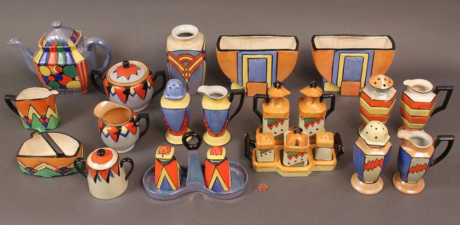 Japanese Art Deco Porcelain Service, 24 pieces: Assembled lot of Art Deco Japanese porcelain in multicolor lustre glaze. Three vases (2 are a pair), 3 sets of muffineers and creamers, One condiment set with tray containing salt and pepper shaker, o