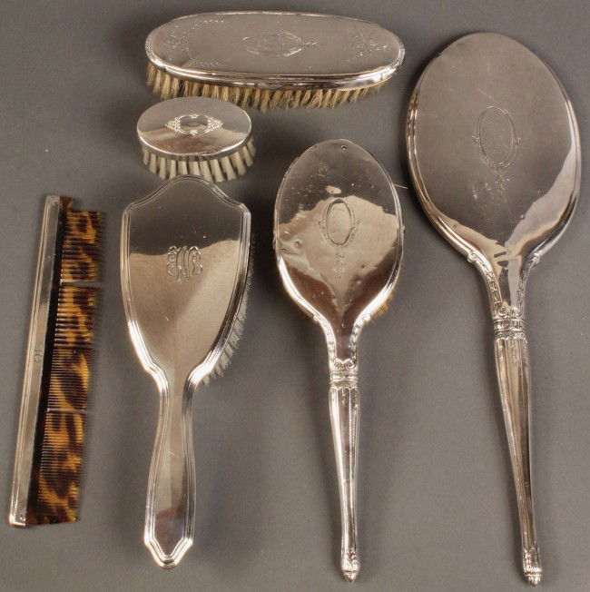 Sterling Dresser set, 6 pieces: Assembled sterling silver dresser or vanity set. Includes hair brush and comb with tortoise shell teeth, both marked Tiffany; hairbrush and hand mirror with engraved and monogrammed decoration, and tw