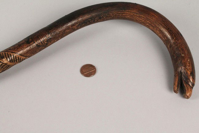 Folk Art Carved Eagle Cane, TN or NC: East Tennessee or Western North Carolina folk art carved eagle cane. Eagle head termination on the curved handle with U.S. eagle, shield and carved feathers along the shaft. Nice patina with overall e