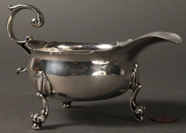 George II Sterling Silver Sauceboat: George II oval sauce boat, engraved with armorial (Juks chevron argent between 3 spear heads), with wavy rim, s-scroll handle and scrolled baroque feet. 1750 date mark, one illegible mark (possibly fo