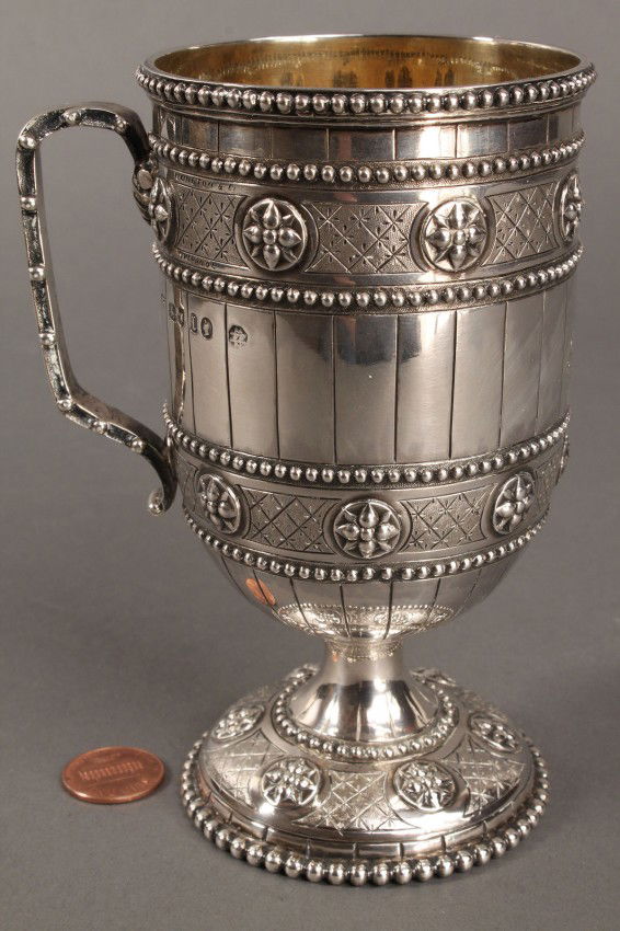 Victorian silver presentation cup, Robt. Hennell I: Victorian Gothic Revival style sterling silver presentation mug, marks for London, sterling, 1866-1867, maker's mark for Robert Hennell II. Also includes an additional crossed swords mark and incised