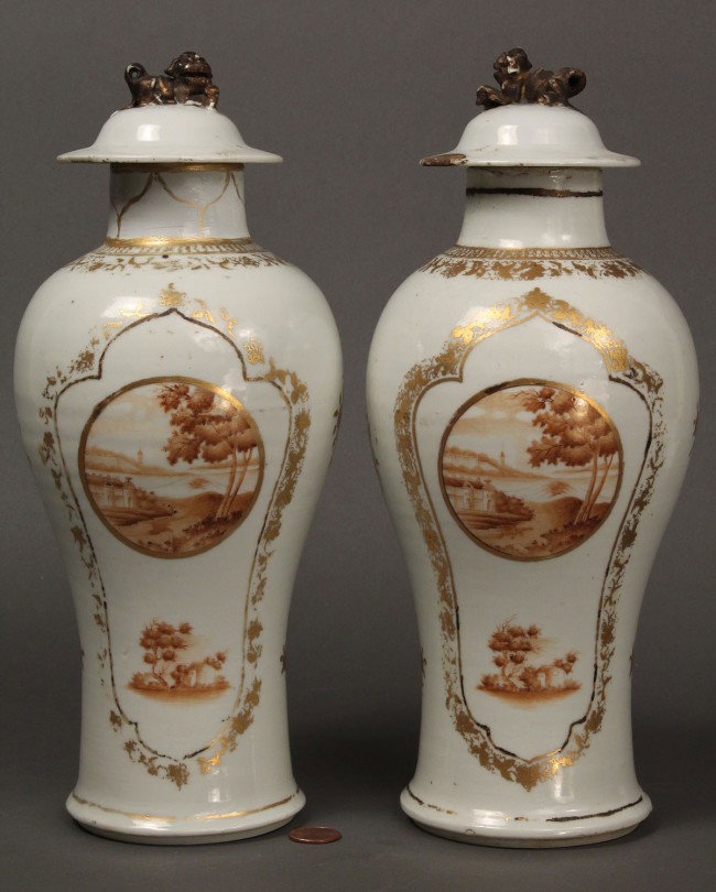 Pair of Chinese Export Baluster Vases: Pair of Chinese Export porcelain garniture or baluster vases, with hand painted landscape vignettes, gilt decoration and dome lids with foo dog finials. Condition - Neck and rim to one vase restored, 