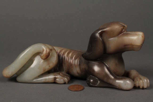 Chinese carved jade dog: Chinese jade carving of a recumbent dog, mottled gray brown color, excellent condition, 20th century. 7-1/4"L x 3" H. Private Nashville, TN collection.