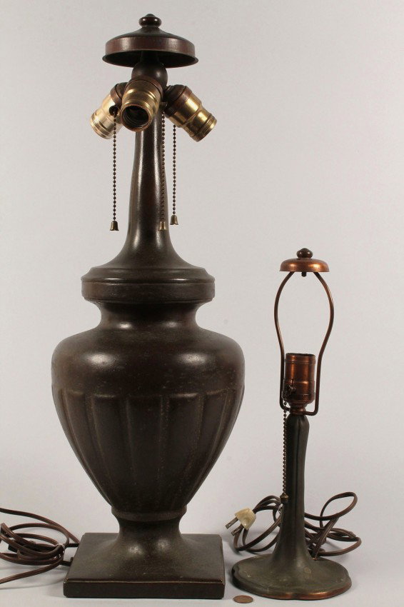 Lot of 2 Handel Lamp Bases: Lot of two Handel lamp bases. One bronzed metal table lamp, urn form, with three sockets, all replaced, (22 3/4" H) and the other a single socket bronzed metal bedroom lamp (13 1/2" H) , both with Han