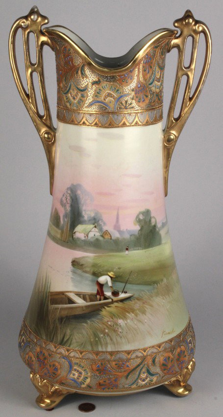 Nippon double-handled vase, hand-painted landscape: Nippon triple-footed, double-handled vase, hand painted landscape scene of coastal meadow with boat and figures, village in background. Elaborate "Moriage" enameled decoration on base and rim, signed 