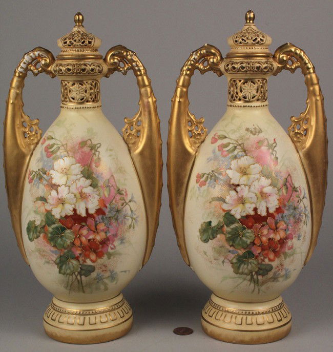 Pair of Austrian Amphora Jars w/ Lids: Pair of Austrian Amphora double handled jars with lids, cream ground with floral bouquet decoration and applied gilt decoration. Stamped red mark on base "Alexandra Porcelain Works, Turn-Austria" with
