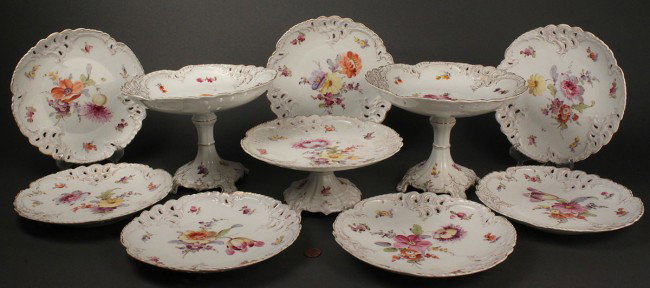 Dresden porcelain fruit or dessert service, 10 pcs: Ten piece partial set of Dresden porcelain tableware. Consists of seven 8" diameter plates with pierced scalloped borders and handpainted floral sprays, two 6"H compotes, and one 3 1/2" compote. Blue 