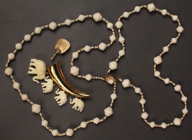 Three Asian themed Miriam Haskell jewelry items: Lot of 3 Asian themed Miriam Haskell Jewelry items.1ST ITEM: Vintage gold-metal tusk-shaped brooch with 4 imitation ivory elephant pendants, 3" L x 2 1/4" H, excellent condition. Signed on back. 2ND I