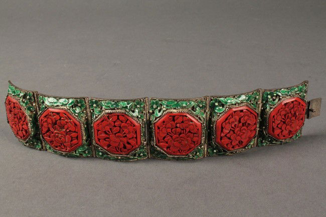 Chinese Art Deco enamel and cinnabar bracelet: Chinese Art Deco panel bracelet, 6 octagonal floral carved cinnabar panels mounted in panels of green floral enamel. Silver backing, impressed "China." Excellent condition with some tarnish. 1-1/3"H x