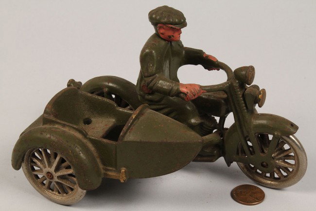 Harley Davidson Cast Iron Motorcycle w/ Sidecar: Harley Davidson cast iron Hubley motorcycle and rider with sidecar. Stamped underside of car seat. Condition - overall excellent, olive drab green, yellow highlights with nickel spoke wheels. Retainin