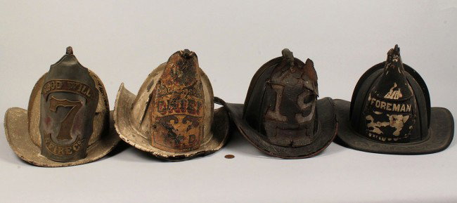 Lot of 4 19th century Fire Helmets: Lot of four 19th century leather Fire Helmets. 1ST ITEM: One black leather fireman's helmet, shield held by greyhound and reading "19". Embossed leather brim.11-1/2" L x 15-1/2" W x 8" D. 2ND ITEM: On
