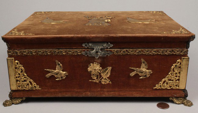Velvet sewing box with assorted tools: Victorian Sewing box, covered in velvet with applied brass deer and bird decorations, brass feet. Condition: scattered wear to velvet and to paper lined interior. 4 1/2" x 11" x 8 3/8". Late 19th cent