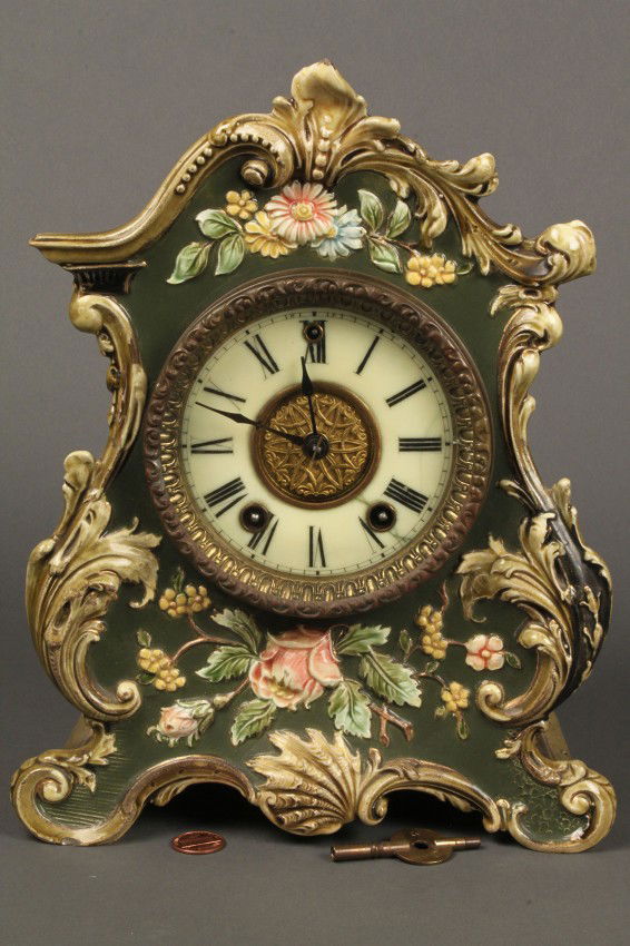 Gilbert Clock Co. Porcelain Mantle Clock: Gilbert Clock Company porcelain Mantle Clock, #5S22, green body with shell and floral decoration. Pendulum missing, key included. 10 3/4" H x 8 1/2" W x 4 1/4" D