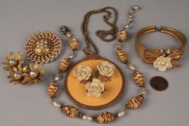 Lot of Five (5) Miriam Haskell Jewelry Items: Lot of Five (5) Miriam Haskell Jewelry Items. 1ST ITEM: Pendant necklace with faux amber disc with gold-metal filigree tri-foil shield and three cream-colored roses and rhinestones. In very good condi