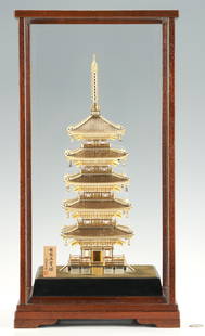 Takehiko Seki Japanese Sterling Silver Pagoda with Case: Seki Takehiko (b. 1908) sterling silver sculpture of a Buddhist Pagoda with giltwash accents, five stories, an ornamental finial, and doors opening to reveal a Gandharan style Buddha in relief.