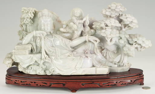 Large Chinese Carved Jade Guanyin & Child: Large Chinese carved celadon and lilac jade sculpture of a recumbent Guanyin, resting her right arm upon a stack of books. Above her left arm is a child standing on one leg and holding a precious