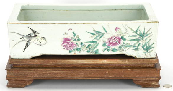 Chinese Famille Rose Jardiniere w/ Stand: Chinese Famille Rose polychrome porcelain rectangular jardiniere or planter with flowering branches, insects, and birds, gilt rim, and bracket feet. Unmarked. Raised on fitted, tiered hardwood stand