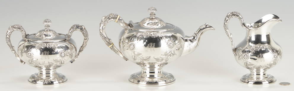 3 pcs. Newell Harding Coin Silver Tea Set: Three (3) piece Newell Harding & Co., Boston, repousse coin silver tea set with floral cartouches surrounding monogram "M" to one side of body and inscription "From Father & Mother" to the other,