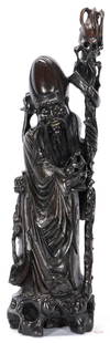 Large Chinese Carved Longevity Figure, Silver Inlay: Carved ebony Chinese longevity figure with foliate decoration inlaid with silver wire representing Shou Xing, the Chinese god of longevity. Depicted with flowing robes, a long beard, and a conical elo