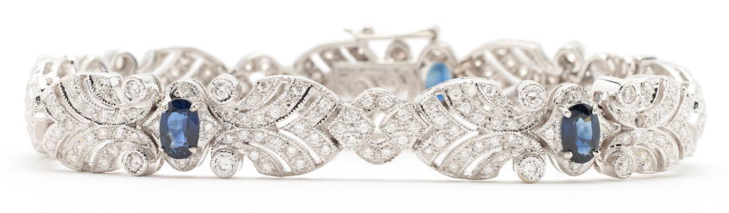 Ladies 18K Diamond & Sapphire Art Deco Bracelet: Ladies 18K white gold art deco bracelet featuring 257 round brilliant diamonds approximately 3.11 carats together, Clarity-VS2, Color-G, and 5 natural oval sapphires. The bracelet is marked "750"