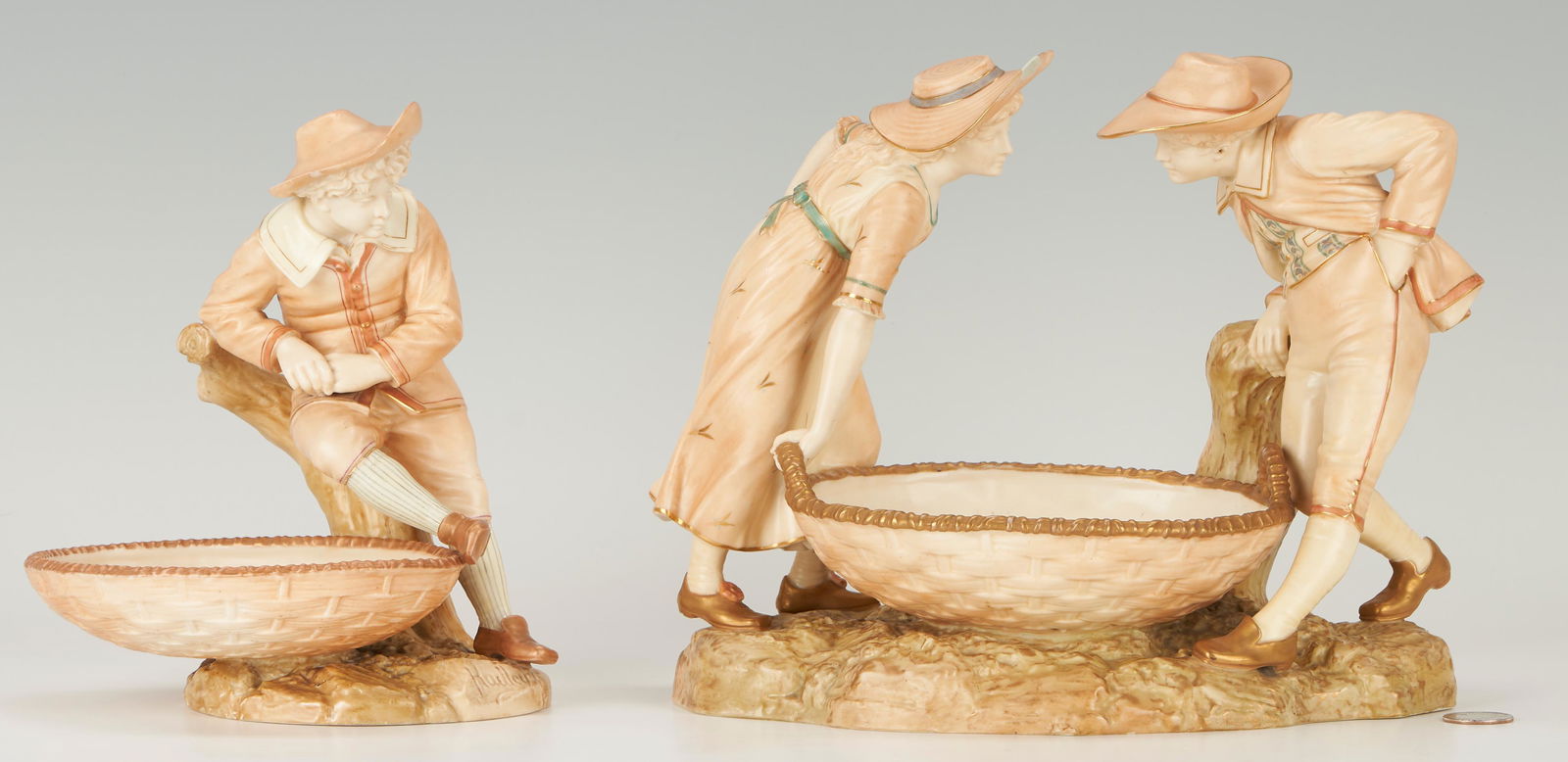 2 Pcs. Royal Worcester J. Hadley for K. Greenaway Porcelain: 1st item: Royal Worcester sweetmeat dish after original model by James Hadley in the Kate Greenaway style. Comprised of a female and male figure intently staring at one another both standing on a natu