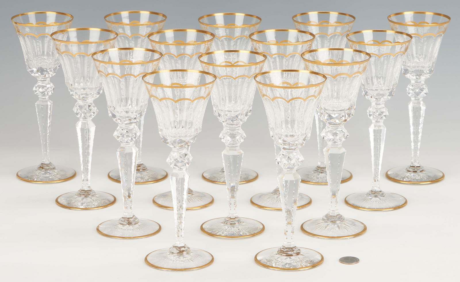 14 St. Louis Excellence Crystal Burgundy Wine Glass: Fourteen (14) Saint-Louis Excellence pattern cut crystal burgundy wine glasses with diamond cut ball, faceted body, notched stem, star cut foot, and gilt scalloped highlights and rims. All items with