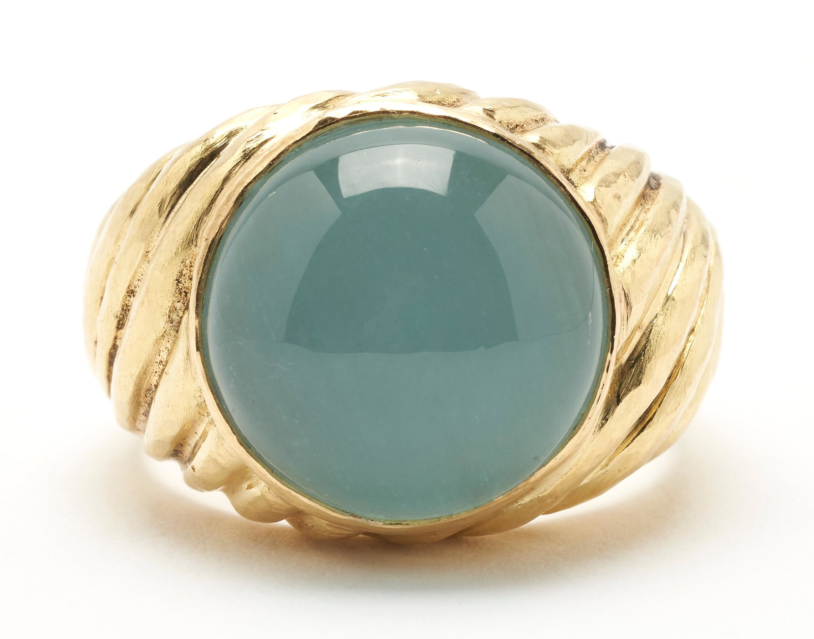 18K Gold & Caldedony Ring: Ladies 18K yellow gold ring featuring a cabochon calcedony stone. The ring has a degraded mark, but tests 18K. The ring is size 10 1/2 and has a gross weight of 15.94 grams. The Estate of Anne Ford, N