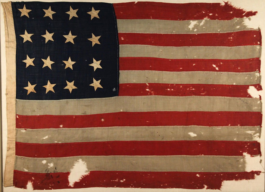 Sixteen Star American Flag, framed: 16 star American national flag. Double ply bunting, hand sewn with a cotton or linen canvas hoist, 3 whipped eyelet grommets. 16 single-appliqued cotton muslin stars. Exhibited Cheekwood Museum of Art