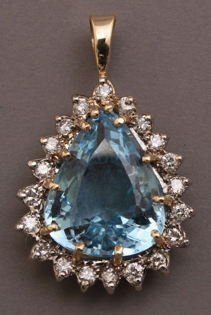 14K pendant w/ 17 ct Blue Topaz & diamond: 14K yellow gold and 17 carat pear-shaped blue topaz and diamond pendant. The blue topaz surrounded by 20 round diamonds together weighing approximately 1 ct. of SI clarity and I-J color. The prongs ha