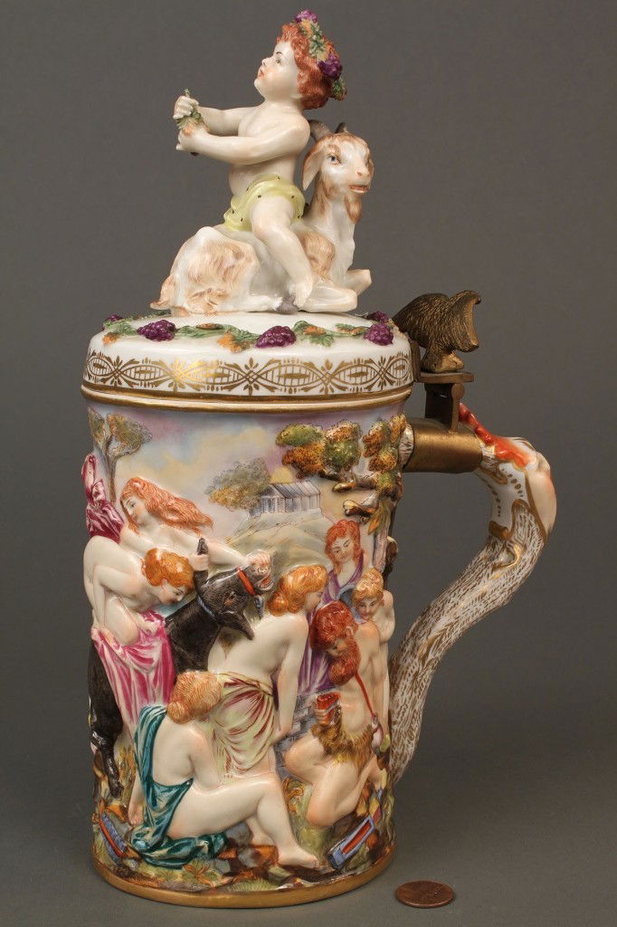 Early Capodimonte Bacchus Tankard marked 2118: Capodimonte decorated tankard with goat and Bacchus cherub finial, relief Bacchus decoration around body and bronze eagle mounted hinge to handle. Blue Capodimonte mark to base with impressed numbers
