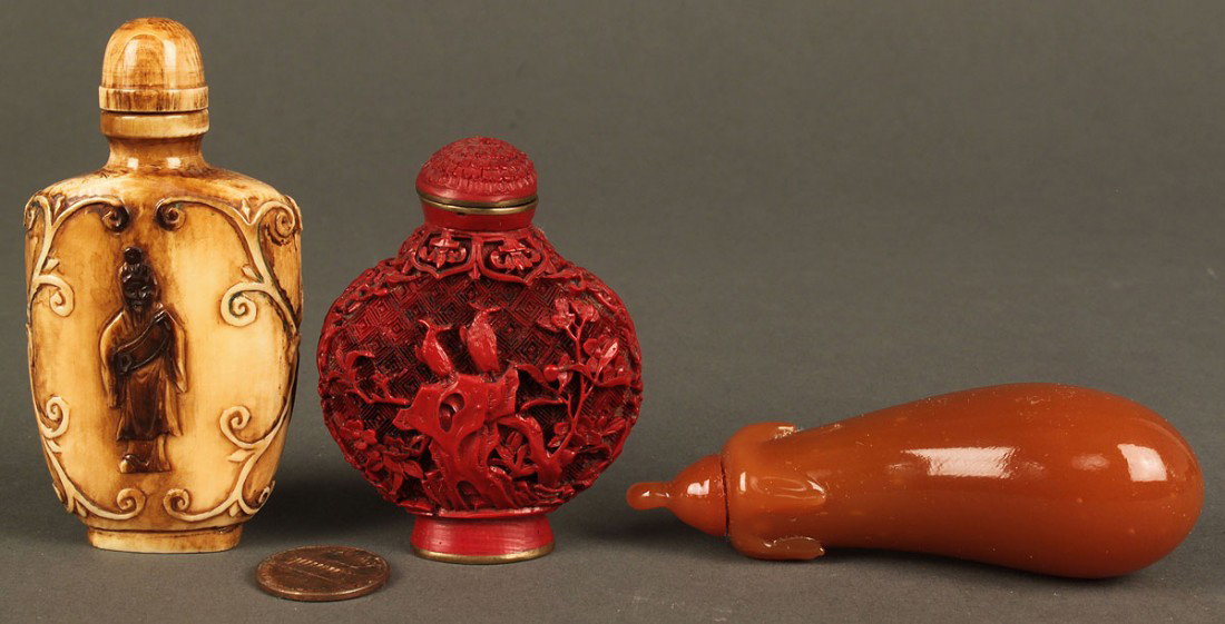 3 Chinese snuff bottles: hardstone,cinnabar,ivory: Lot of 3 Chinese snuff bottles. 1ST ITEM: Eggplant shaped hardstone snuff bottle, russet color, with stem form top. 3 1/4" L. 2ND ITEM: Carved cinnabar urn shaped snuff bottle with bird, insect and fo