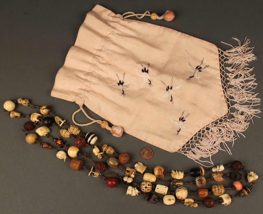 Collection of 52 Asian Ojime beads w/ Silk Pouch: Collection of 52 Asian Ojime beads, strung as a necklace, most carved ivory but also including cinnabar, nut, bone, stone and wood examples, a few artist signed. Included in this lot is a pink silk ba