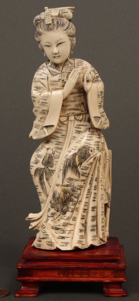 Japanese Carved Ivory Okimono, Geisha: Japanese carved ivory okimono depicting seated female with hands in Buddhist pose wearing robe decorated with carved koi and pine branch. Fixed to stand. 8" H (including base). Late 19th - Early 20th 