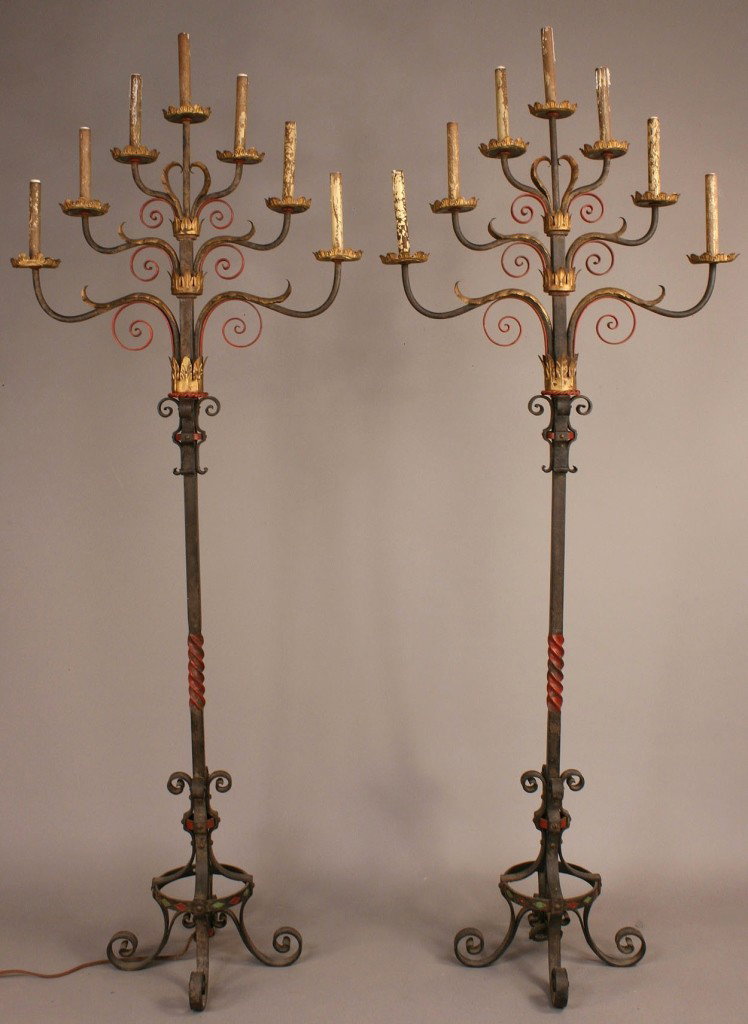 Pair iron torchiere lamps, manner of Oscar Bach: Pair of wrought and painted iron, tin and wood torchieres, manner of metalwork designer/craftsman Oscar Bach (Germany/New York, 1884-1957). Each candelabra features seven arms, all adorned with painte