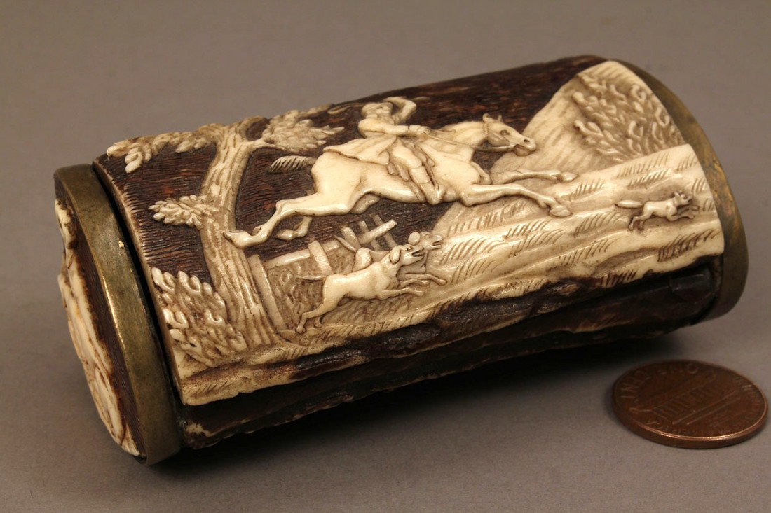 Small horn trinket or snuff box: Small horn trinket or snuff box with incised decoration of fox hunt scenes. Brass hinges and mounts. 3 1/8"w x 10/16"d x 1 1/4"h. Probably Asian, late 19th century. Provenance: Estate of A. Welling La