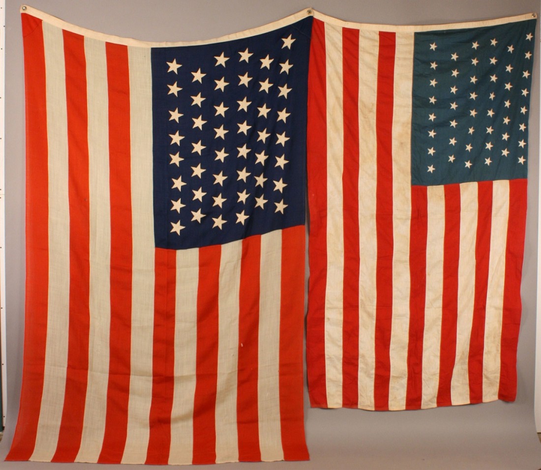 Lot of two 46 star American flags: 1ST ITEM: 46 star American national flag, wool, inscribed L.C. Sanders or Saunders on hoist. Approximate size 5' x 7-1/2'. 2ND ITEM: 46 star American national flag, cotton, all machine stitched with s