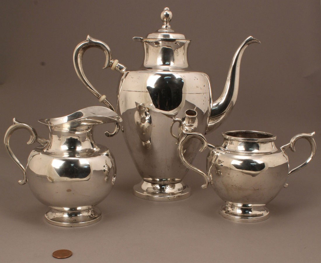 Mexican sterling silver tea set, 3 pcs.: Three-piece Mexican Sterling silver tea service, consisting of tea or coffee pot with ivory ferrules, creamer, and open sugar (may have originally had a lid). Each piece marked on bottom: Joyeria Real