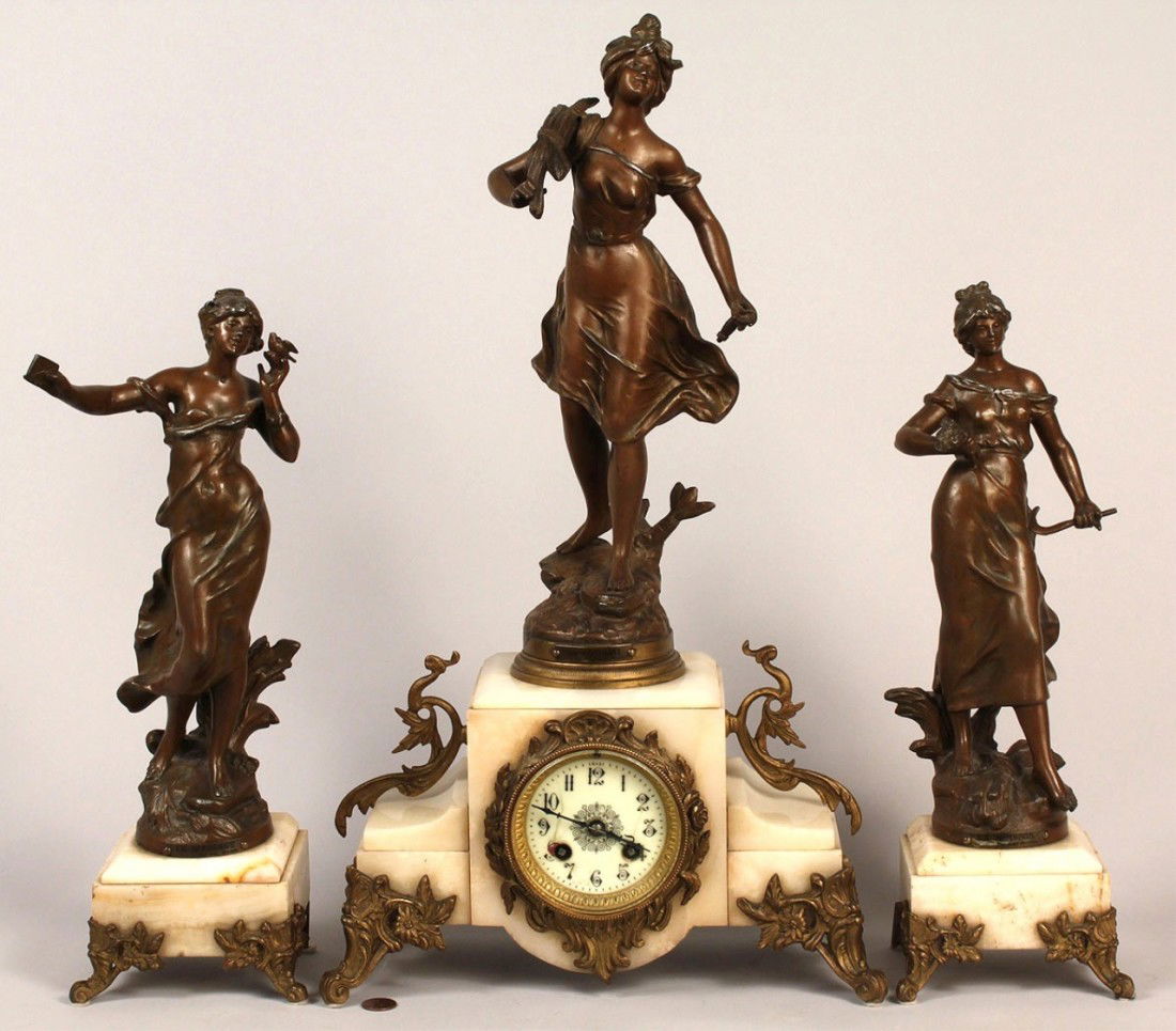 3 Piece French Metal Garniture Set, after Moreau: Three piece French garniture set, after Auguste Moreau (French, 1834-1917) comprised of three female sculptures on marble bases, the center sculpture also having a clock face. All pieces marked "Fabri