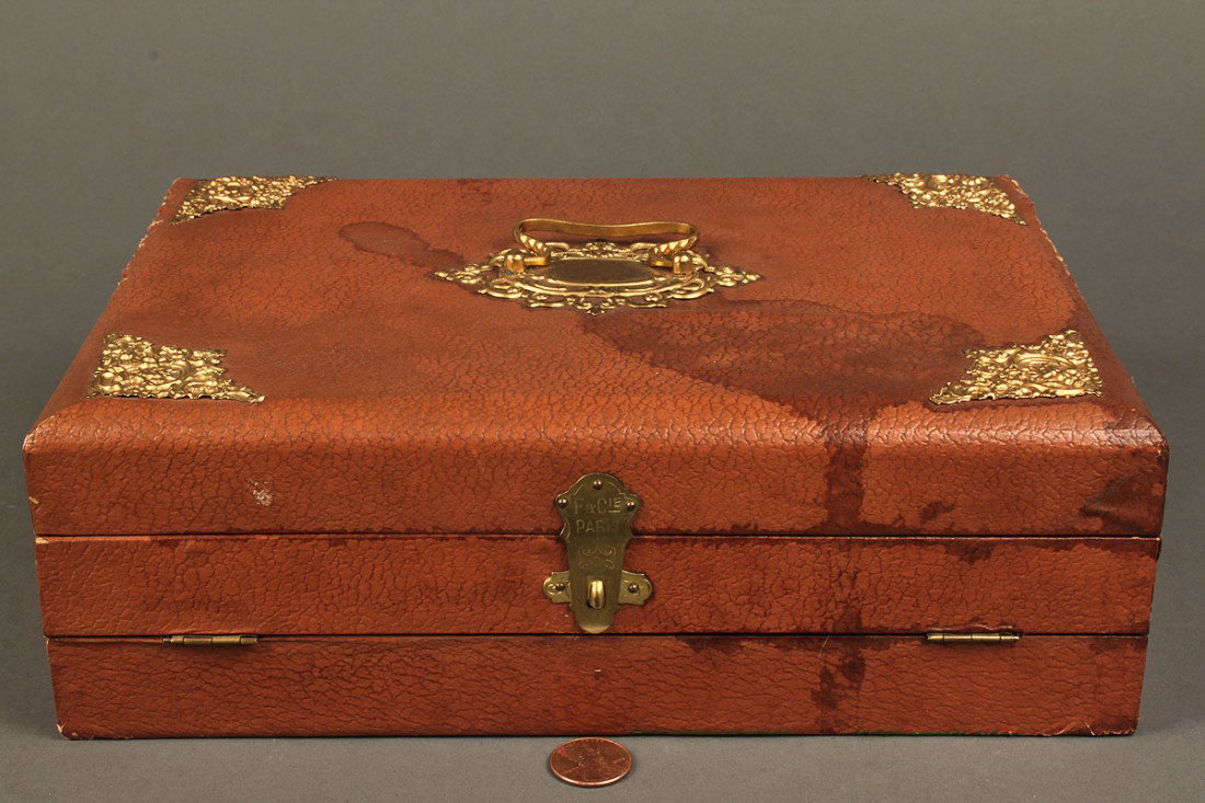 French ladies box w/ sewing & stenciling supplies: Leather or faux leather covered box with brass corner mounts, handle and latch, marked F. and Cie Paris, with fitted interior and contents including copper stencils, 4 ivory sewing tools, needles and