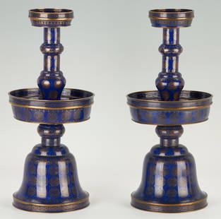 Pair Chinese Qing Cloisonne Candlesticks: Pair of two (2) rare Chinese cloisonne pricket candleholders with gilt shou, foliate, and fret designs throughout on a cobalt blue ground; circular drip pans; and bell shaped bases. 16" H x 7 1/4"