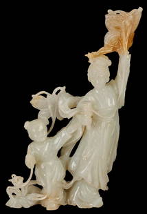 White Jade Mother & Child Figure: Chinese white jade figural group depicting a mother and child or Guanyin and child attendant, surrounded by butterflies, flowers, and vines. A russet colored inclusion forms the uppermost butterfly