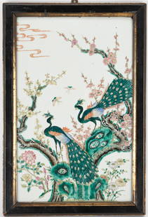 Chinese Famille Rose Framed Porcelain Plaque, Birds of Paradise: Chinese Famille Rose porcelain plaque decorated with two peacocks perched in a tree, spring foliage, and two butterflies fluttering above, against a white background. Unsigned and unmarked. Housed in